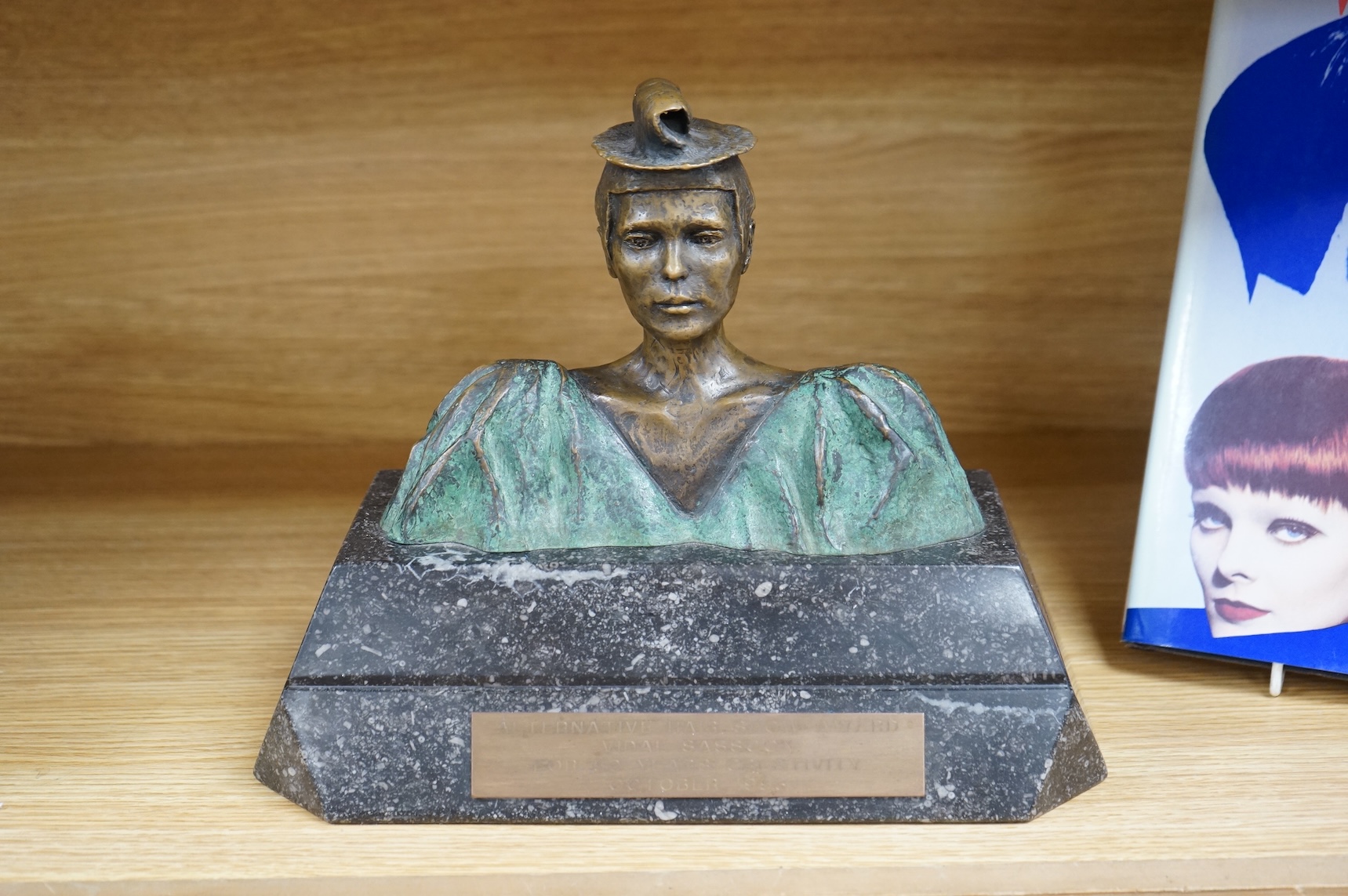 A figural bronze award: Alternative Hair Show Award Vidal Sassoon for 50 Years Creativity October 1993, together with Vidal Sassoon Fifty Years Ahead, a photographic history of his work. Award 29cm wide x 25cm high.